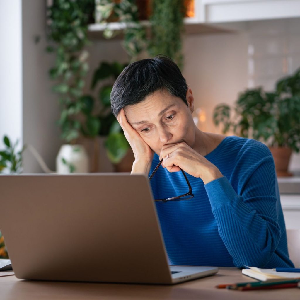 woman looking sad reading off putting job ads