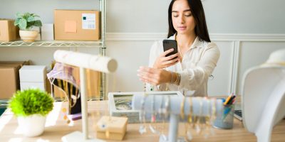 A girl photographing jewellery to sell